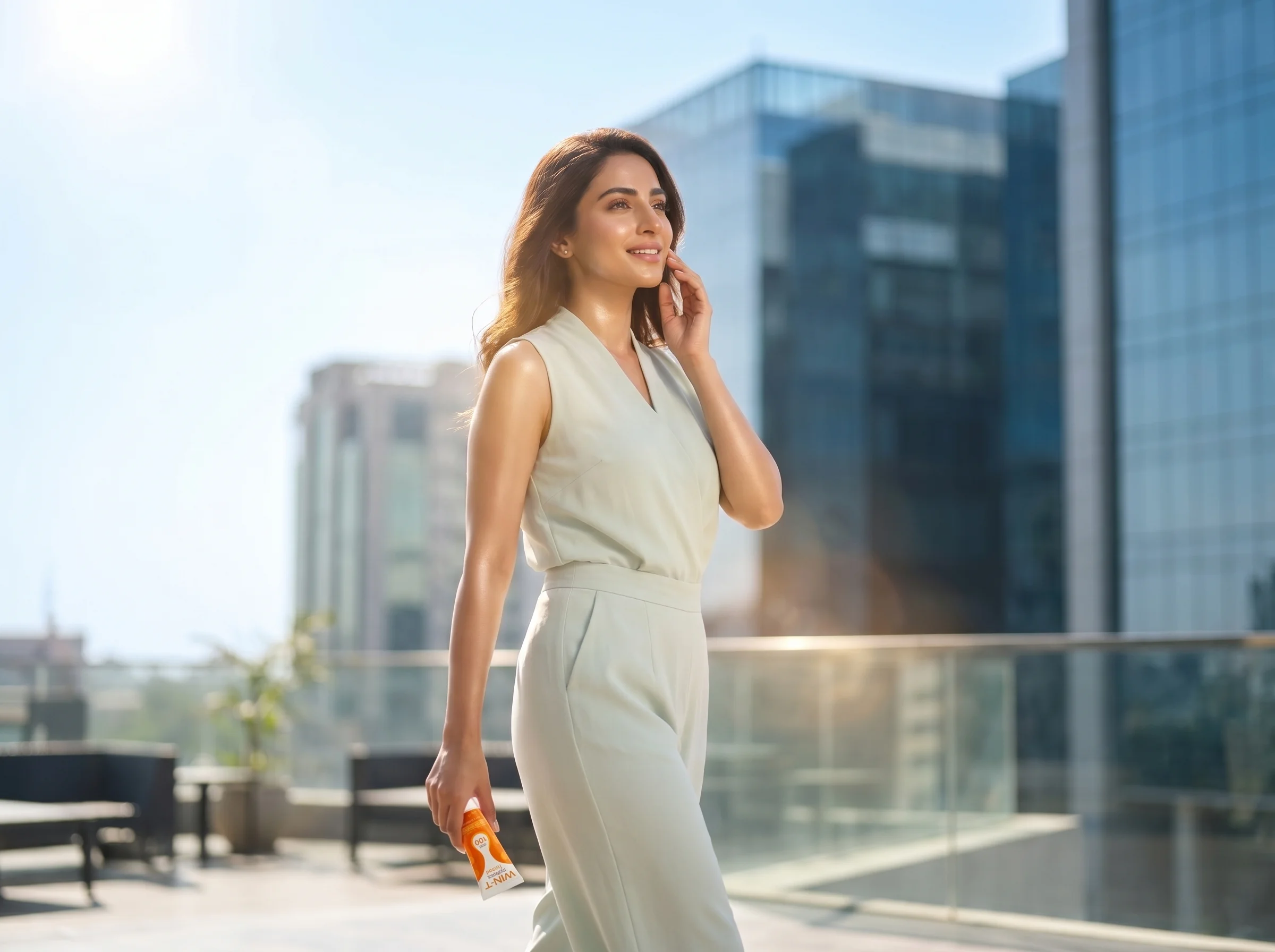 Woman outdoors under strong sunlight using WIN-T SPF 100 sunscreen, representing daily UV defense and skin protection.